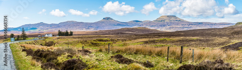 A panorama view across the heathland on the island of Skye towards the flat topped mountains of MacCeods tables, Scotland on a summers day