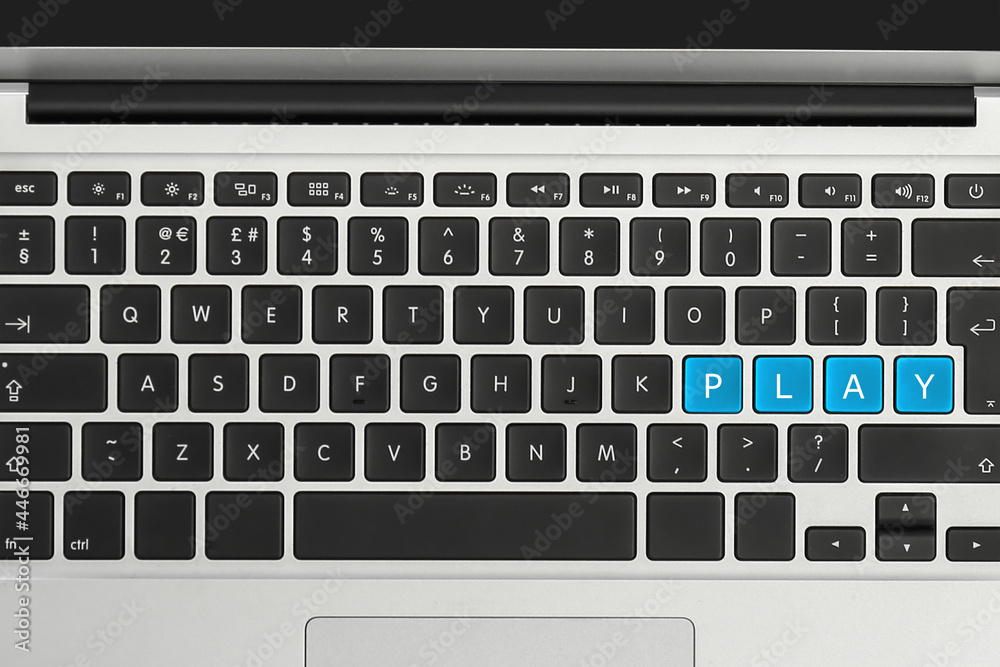 Blue buttons with letters P L A Y on laptop keyboard, top view Blue buttons with letters P L A Y on laptop keyboard, top view