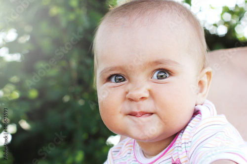 Cute cheerful infant baby girl outdoors