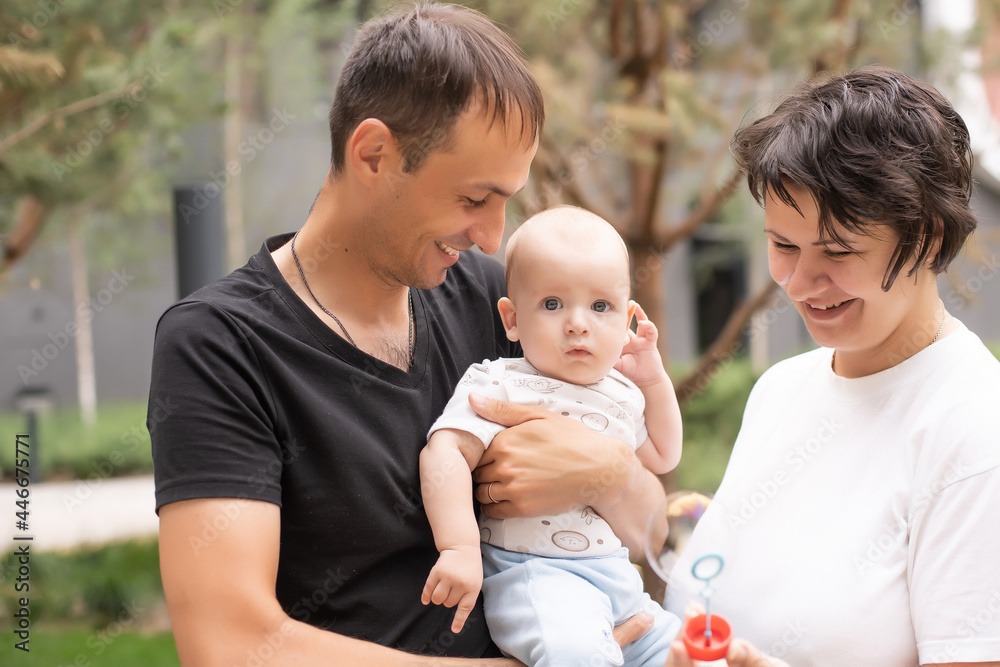 Happy family: mother father and child on nature Happy family: mother father and child on nature