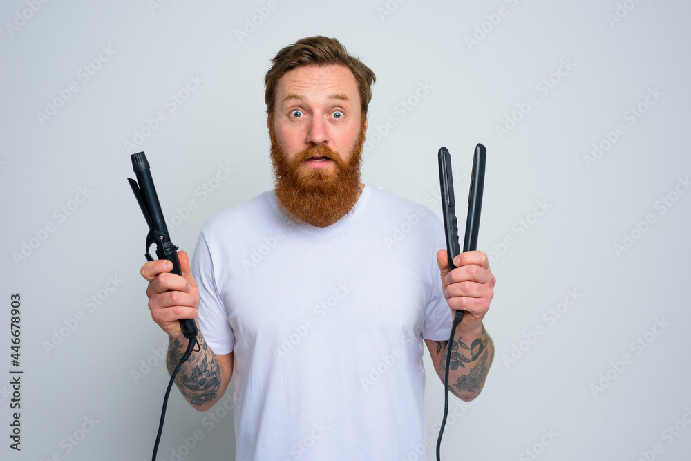 Wondered man with hair straightener is ready to work Wondered man with hair straightener is ready to work