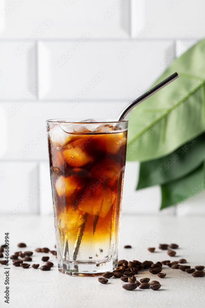 Cold drink with espresso and tonic in glass on white background, vertical Cold drink with espresso and tonic in glass on white background, vertical