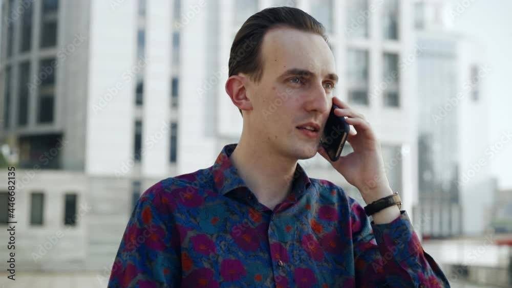 Close-up of a man talking on the phone in a business area Close-up of a man talking on the phone in a business area