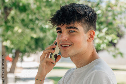 portrait of teenage boy talking on mobile phone