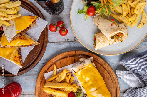 Tableau sur toile cheddar cheese burrito, wrap and quesadilla with french fries and salad