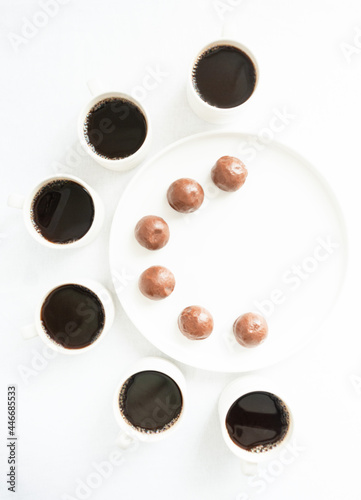 Time for coffee. white mugs with coffee on a white background with dessert in a plate
