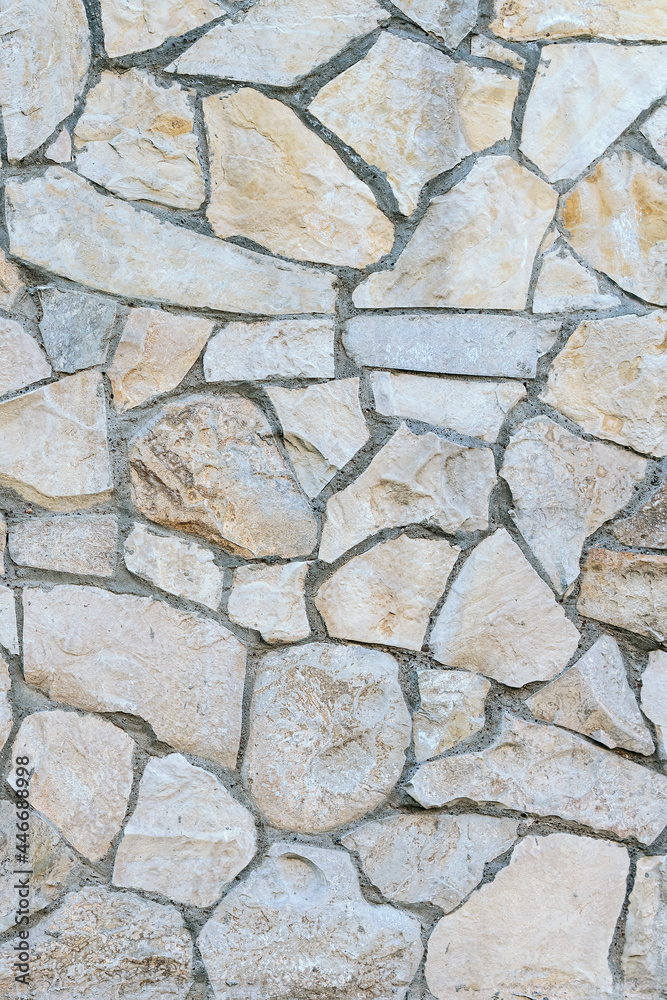 Obraz premium stone wall made of sandstone blocks of different sizes as the background