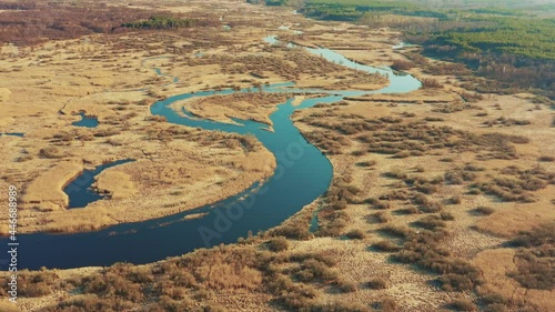 Aerial View Of Forest Woods And Partly Frozen River Landscape In Sunny Late Autunn Day. Top View Of Beautiful European Nature From High Attitude In Autumn Season. Drone View. Bird's Eye View photo