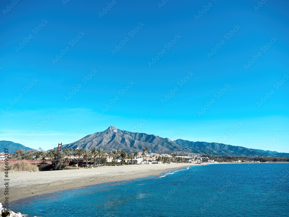 Marbella beach with blue sky and the shell behind. La Concha is the most famous mountain in Marbella