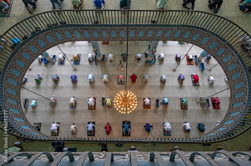 View of many people praying in a big islamic mosque in Dhaka, Bangladesh. photo