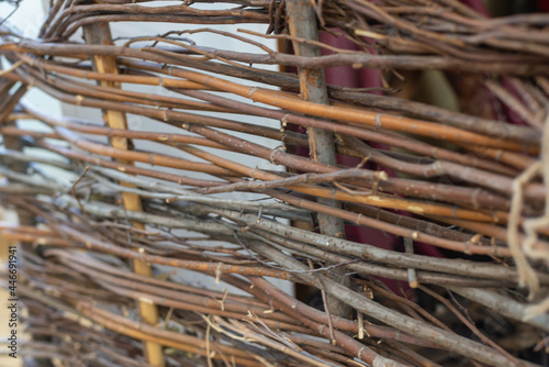 Old wooden fence made of branches.