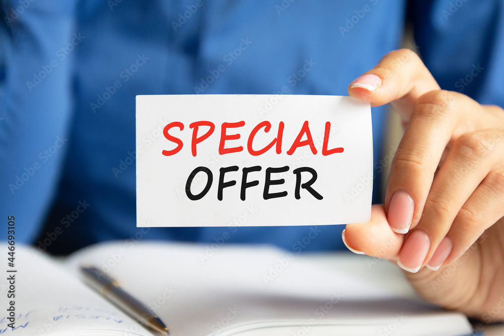 special offer written on a paper card in woman hand special offer written on a paper card in woman hand
