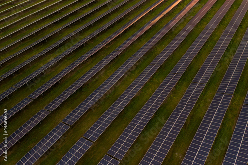 Aerial view of solar fields in a land at sunset at FP&L Solar Field industries in Micco, Florida, United States. photo
