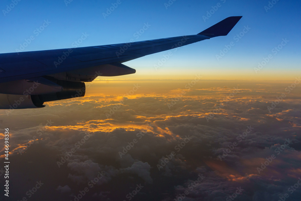 Fototapeta premium Beautiful sunrise with aircraft wing during View from windows aircraft