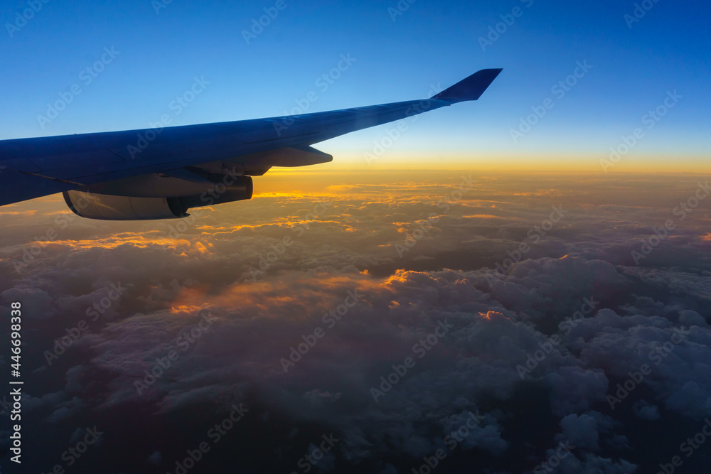 Fototapeta premium Beautiful sunrise with aircraft wing during View from windows aircraft