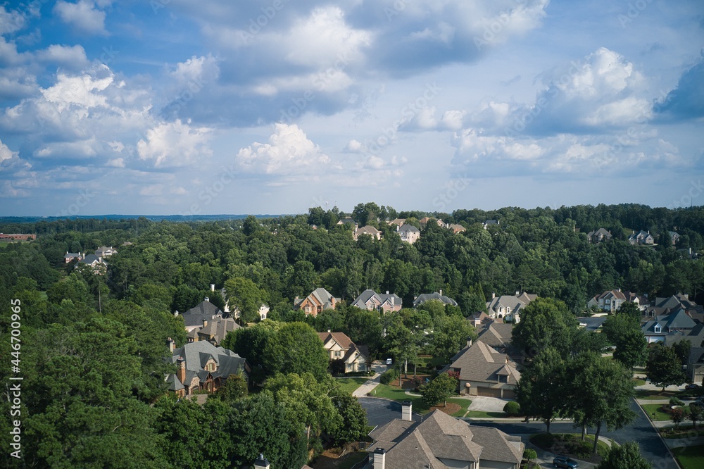 Aerial view of a sub division with beautiful landscape and houses