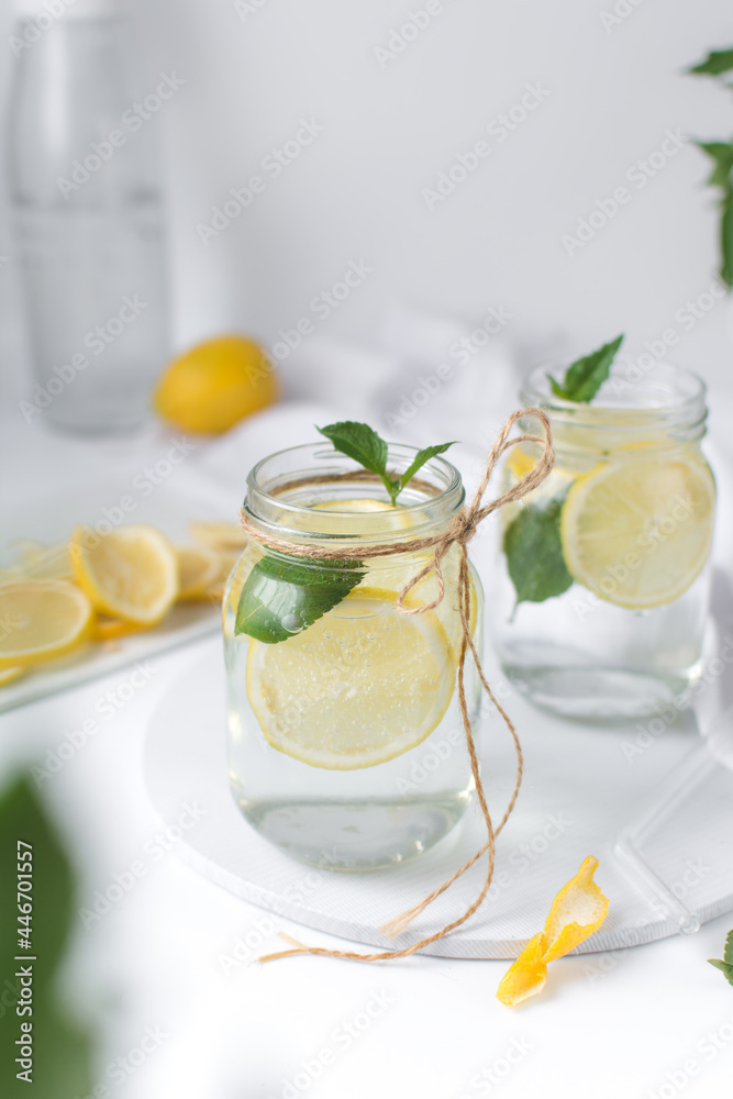 Fototapeta premium Lemon lime soda in a mason jar with a lemon slice and basil leaves, lemonade in a glass jar