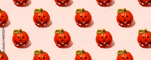 Ceramic jack-o-lantern candlestick on pink. Seamless pattern. Halloween concept, hard shadow, banner, printshop, flyer for seasonal party with copy space
