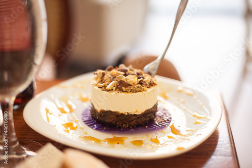 Selective blur on an American New York Style cheesecake with figs covered with almonds It is a recipe unsing the traditional ingredients of cheesecake, adding cooked figs...