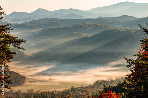 Sunrays shine through fog and Smoky Mountain hill tops on cloud covered valley floor  along Foothills Parkway photo