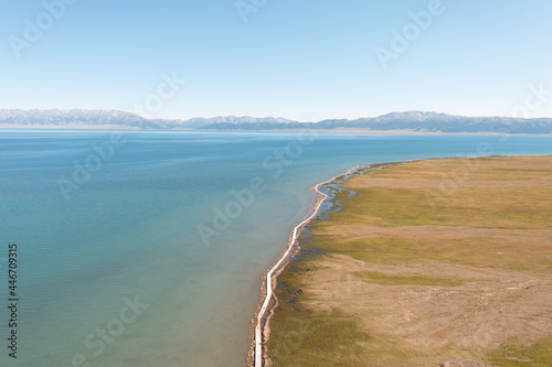 Lake and grassland with a sunny day. Shot in Sayram Lake in Xinjiang  China.