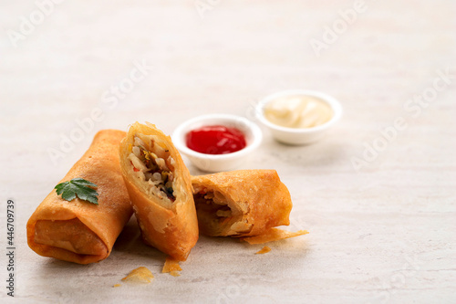 Close Up Deep Fried Spring Rolls, Popular as Lumpia (rebung) or Popia. Served on Stone Table, SIolated with Copy Space for Text photo