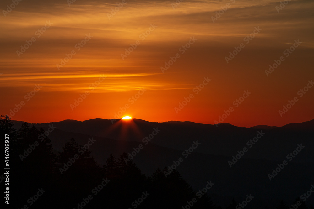 Warm orange Sunrises over silhouetted forest and mountain tops at New Foundland Gap in the Great Smoky Mountains