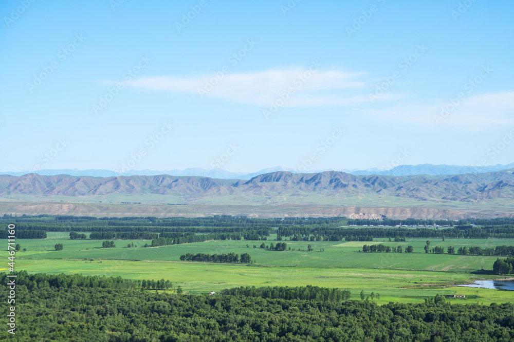 Grassland and mountains in a sunny day. Grassland and mountains in a sunny day.