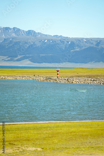 Road and lighthouses on the lake. Shot in Sayram Lake in Xinjiang, China. photo