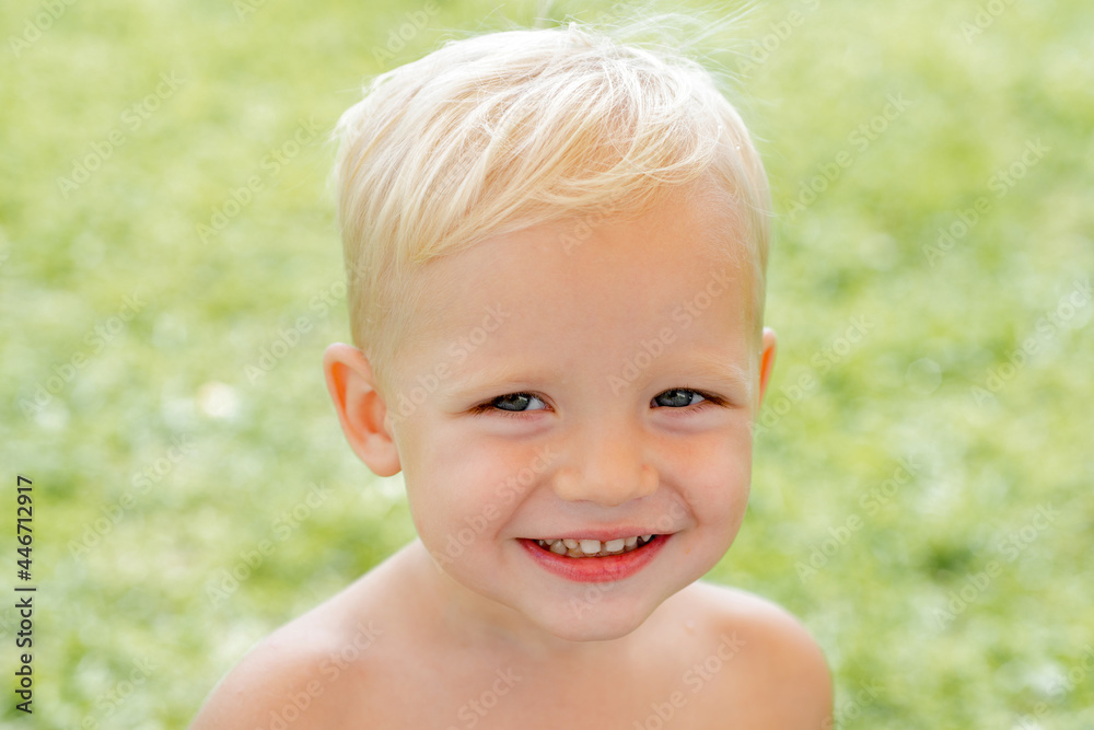 Happy child portrait. Funny boy. Happy boy standing in grass at sunny summer day. Happy day. Happy child portrait. Funny boy. Happy boy standing in grass at sunny summer day. Happy day.