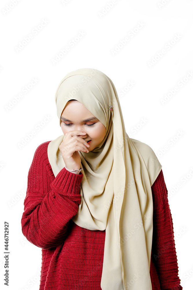 Portrait face expression of Muslim asian lady wearing hijab smells something bad Portrait face expression of Muslim asian lady wearing hijab smells something bad