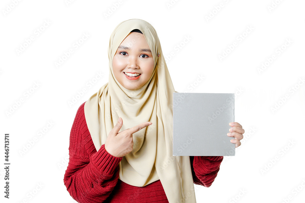 Beautiful Young Muslim girl holding a white cardboard over white background Beautiful Young Muslim girl holding a white cardboard over white background