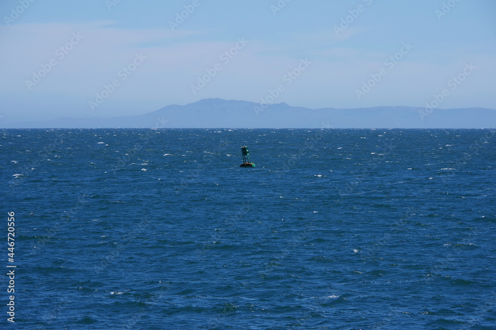 Looking over the Santa Barbara Channel to Santa Cruz island with some fog clouds in the back on an early summer day