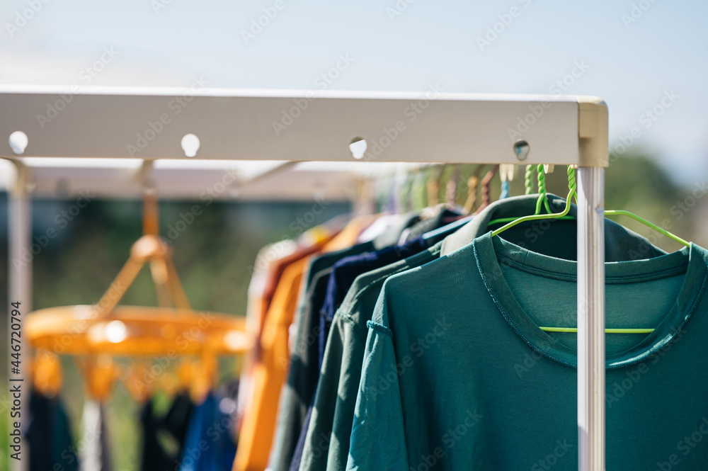 Clothes hanging on clothesline outdoors for drying in sunny day