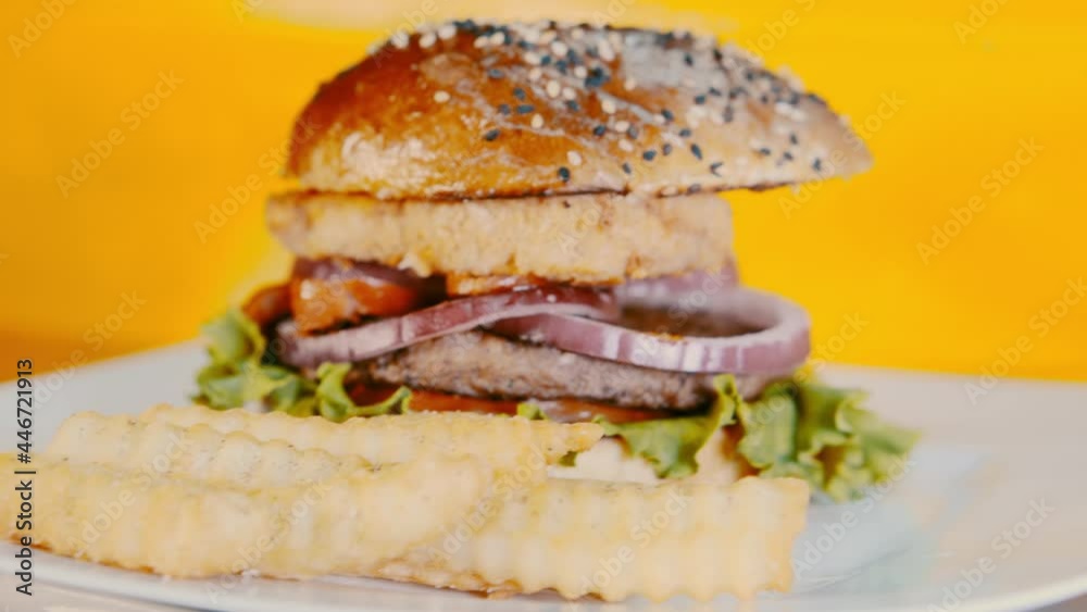 Juicy burger with fresh vegetables and french fries. Street food concept Juicy burger with fresh vegetables and french fries. Street food concept