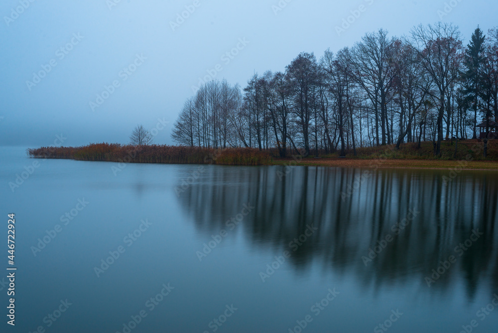 Moody autumn in the early morning lake in Belarus