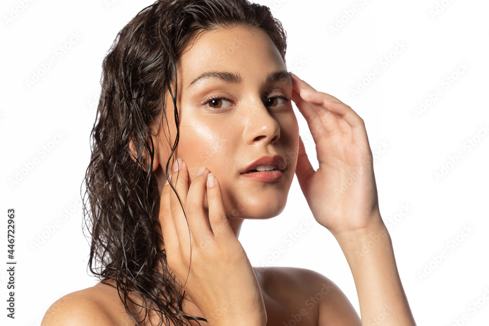 © deniskomarov - Skincare and natural woman beauty. Young female with wet hairs after bath touch healthy pure face. Close-up studio portrait of beautiful sensual girl touching glowing hydrated facial skin. © deniskomarov - Skincare and natural woman beauty. Young female with wet hairs after bath touch healthy pure face. Close-up studio portrait of beautiful sensual girl touching glowing hydrated facial skin.