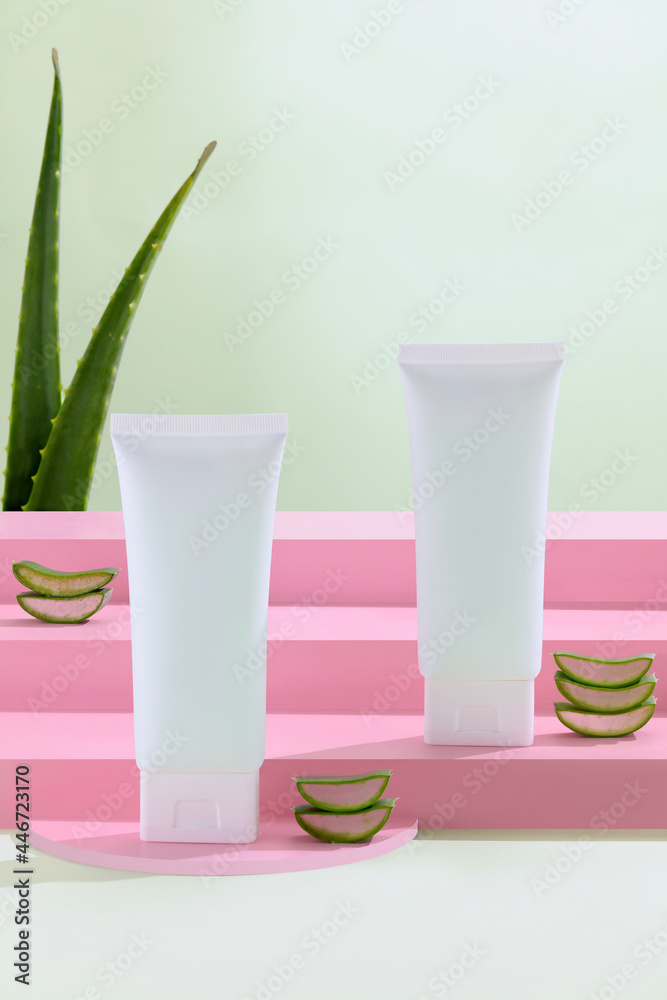 Background with natural cosmetics of aloe vera, fresh leaves of aloe on bright green and Stairway and podium geometrical texture for banner and product presentation Background with natural cosmetics of aloe vera, fresh leaves of aloe on bright green and Stairway and podium geometrical texture for banner and product presentation