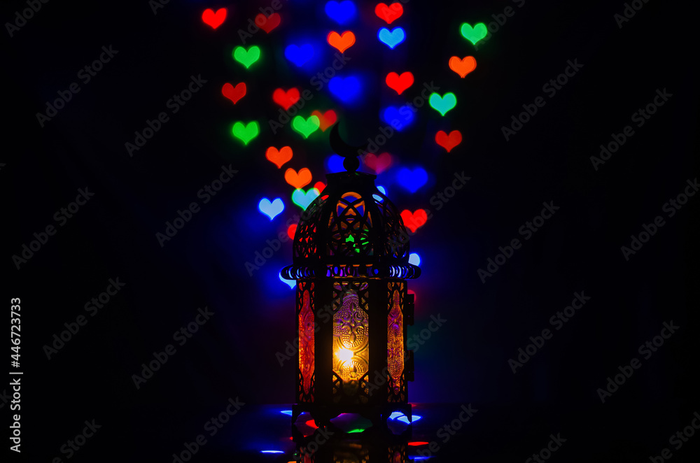 Lantern with colorful love shape bokeh lights for Islamic new year and Ramadan Kareem concept.
