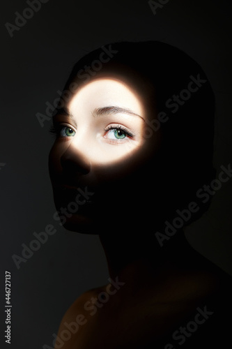 portrait of young woman with light on her face