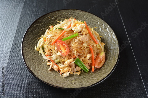 stir fried vermicelli rice noodle with vegetables and meat in black background asian banquet menu