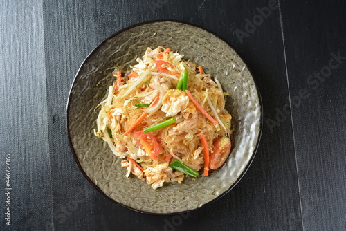 stir fried vermicelli rice noodle with vegetables and meat in black background asian banquet menu