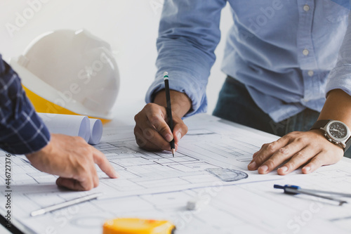 engineer meeting for an architectural project. working with partner and engineering tools working on blueprint architectural project at the construction site at desk in the office.