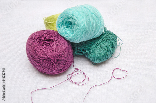 skeins of thread on a white background, multicolored skeins of thread for needlework, skeins of thread close-up