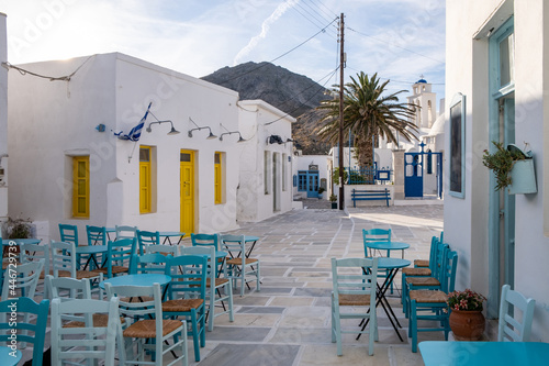 Serifos island, Chora, Cyclades Greece. Open empty cafe tavern chairs tables background. photo