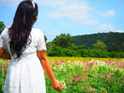 Woman white dress and beautiful floral ans mountaiin in nature background photo