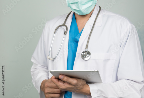 Medicine doctor working with his digital tablet in the hospital. medical staff in uniform