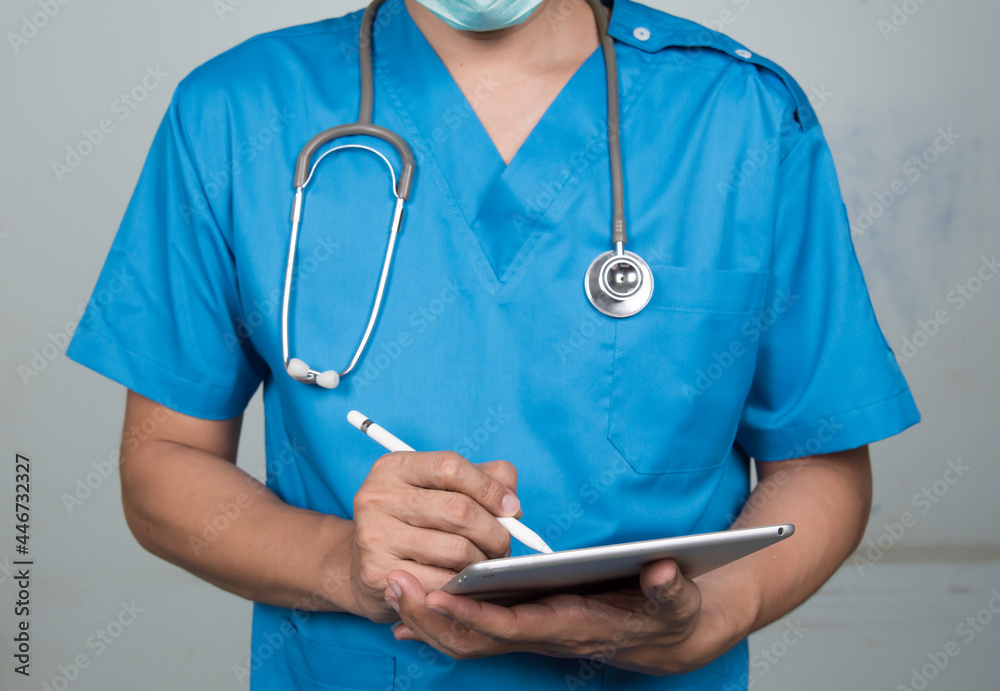 Medicine doctor working with his digital tablet in the hospital. medical staff in uniform Medicine doctor working with his digital tablet in the hospital. medical staff in uniform