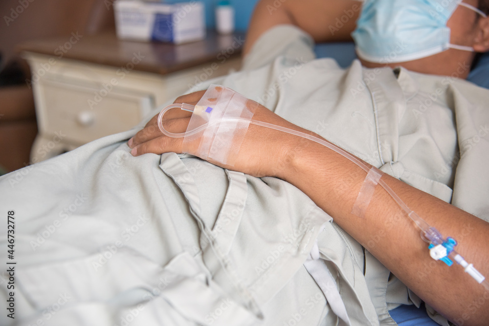 Patient in patient set is the bed in the private room in the hospital. Isolated patient in hospital. Isolation covid ward, with IV fluid. Patient in patient set is the bed in the private room in the hospital. Isolated patient in hospital. Isolation covid ward, with IV fluid.