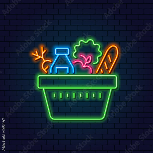 Neon Grocery Cart. Basket with vegetables, fruits, milk and bread. Concept for Grocery Store, Consumer Basket. Glowing neon sign on a dark background.